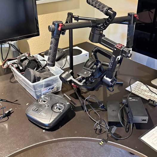 DJI Ronin M handheld gimbal stabilizer with grip, phone mount, and control module