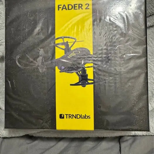 Electronics accessory package with yellow FADER 2 label and TRNDiLabs logo