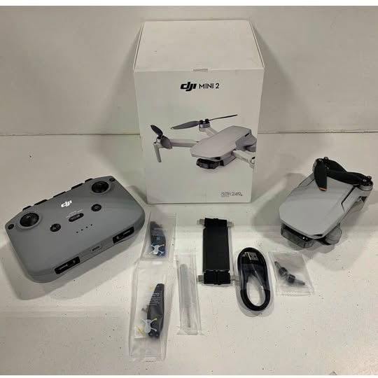DJI Mini 2 drone kit with controller, propellers and accessories, shown with retail box