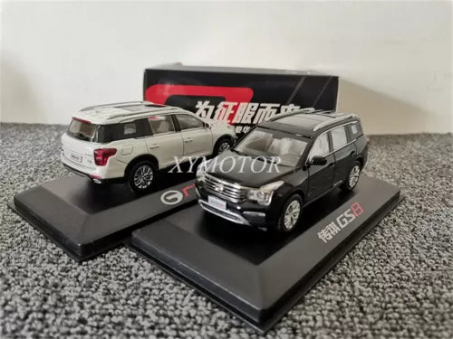 Diecast MPV model car set in black and white, on display base