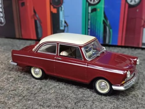 Maroon classic diecast car with white roof and chrome details