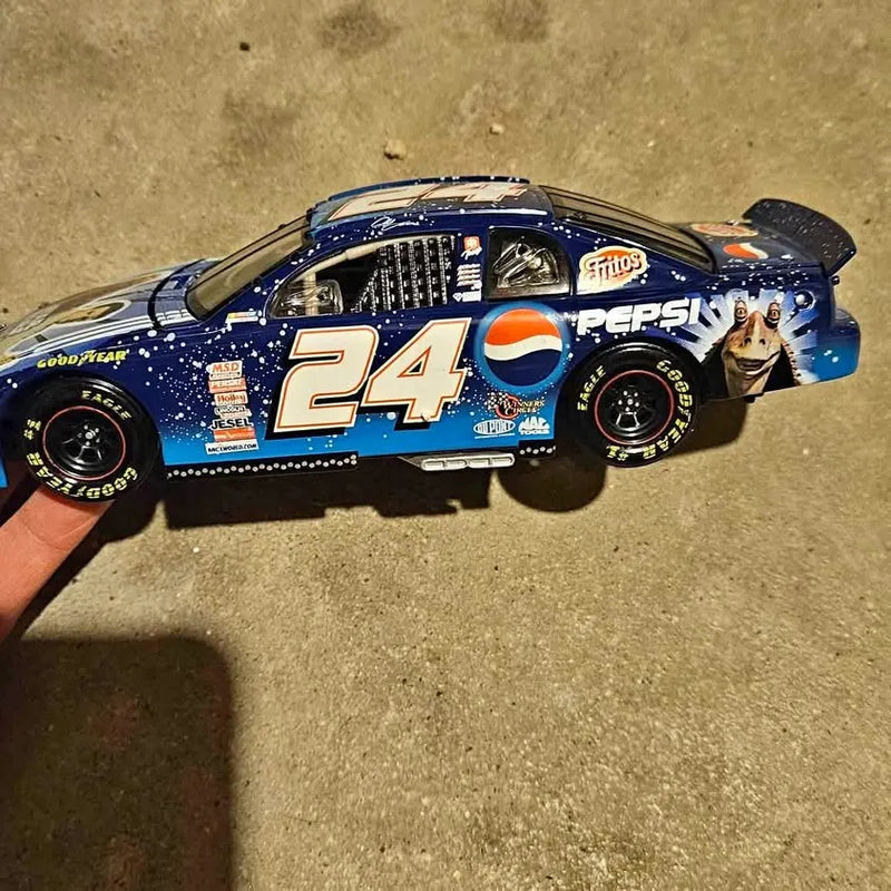 Diecast race car model in blue with #24 and Pepsi graphics