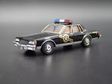 1:64 scale diecast police sedan model car, black with tan interior, sheriff logo