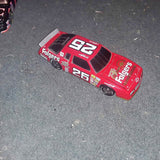 Red 1:24 diecast stock car bank with #97 and #26 decals