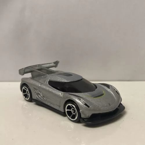 1/64 diecast sports car model in metallic silver with black roof and hood vents.