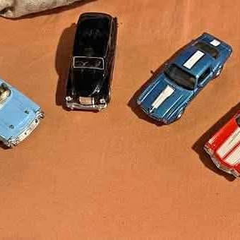 Die-cast car set with black and blue cars, plus partial light and red cars