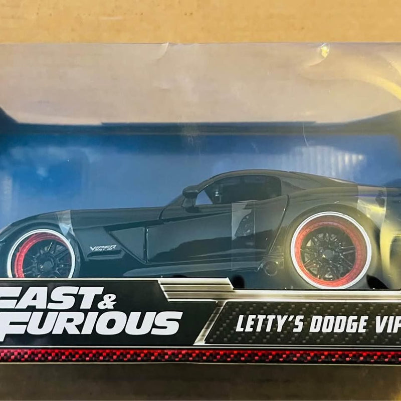 Diecast toy car in dark green and black with red-trim wheels, 1:24 scale