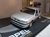 Silver sedan diecast model car with front view, on display base