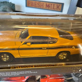 Vintage yellow diecast muscle car with black stripe, side view in clear display box