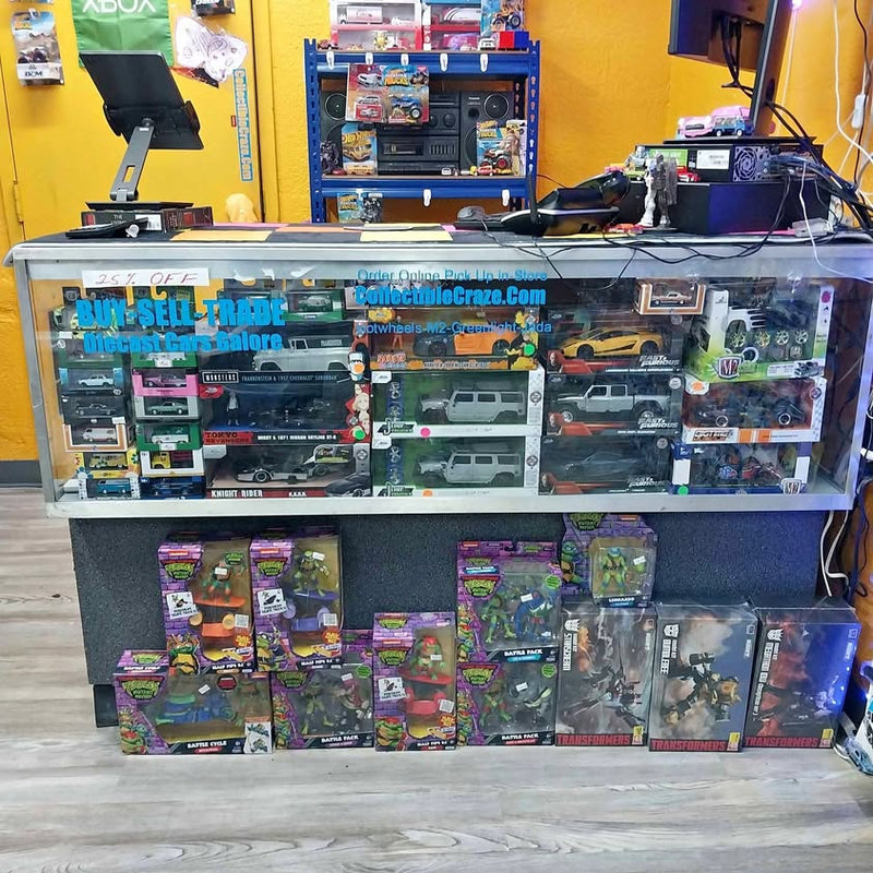 Diecast model car display case with multiple boxed vehicles on shelves