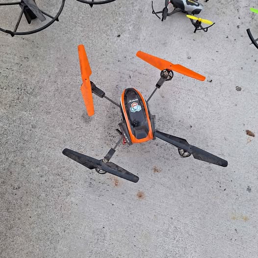 Orange quadcopter drone with four propellers