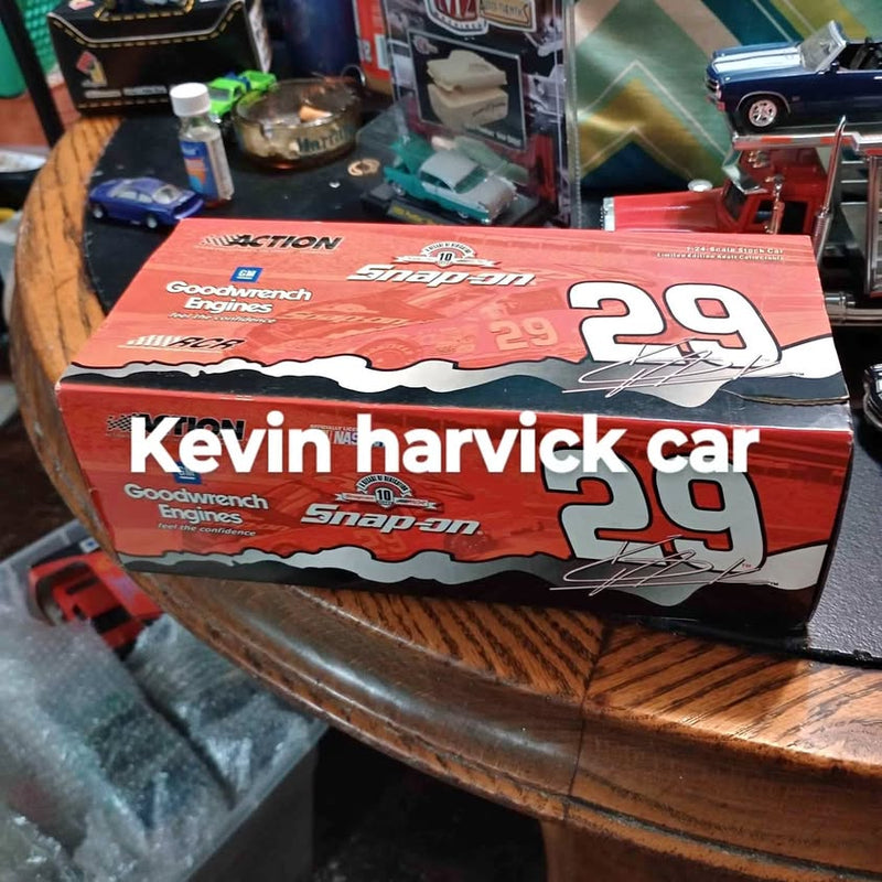 Diecast car in printed retail box, red and black race branding with driver name Kevin Harvick.