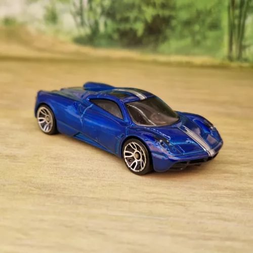 Blue diecast race car model with gold rims and black rear wing detail