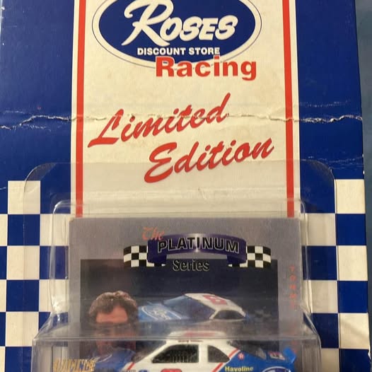 Collectible diecast race car in clear blister, blue and white with racing decals
