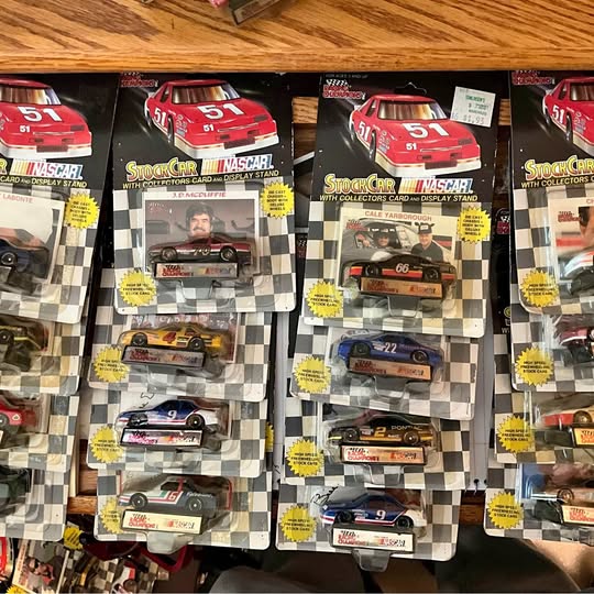 NASCAR diecast car display in blister packages with red race cars in multiple slots