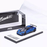 Blue diecast sports car model on display base with open clear box