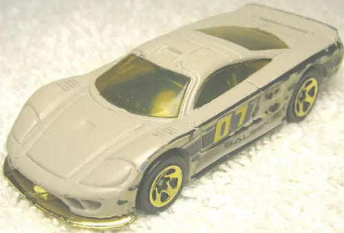 Light gray diecast race car with #07 decals and yellow wheels