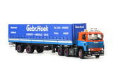 Blue and orange diecast semi-trailer truck with blue tarped trailer and front cab