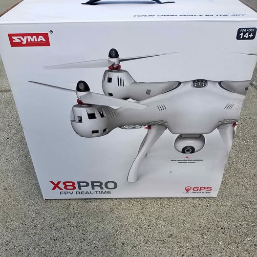 FPV drone in retail box, white quadcopter with antennas and GPS label