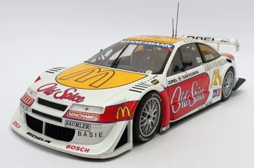 Diecast race car model in white, red, and yellow with front 3/4 view, detailed body.