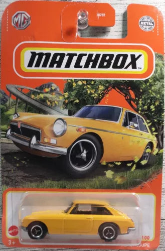 Yellow diecast MGB GT coupe model in retail blister package with black wheels
