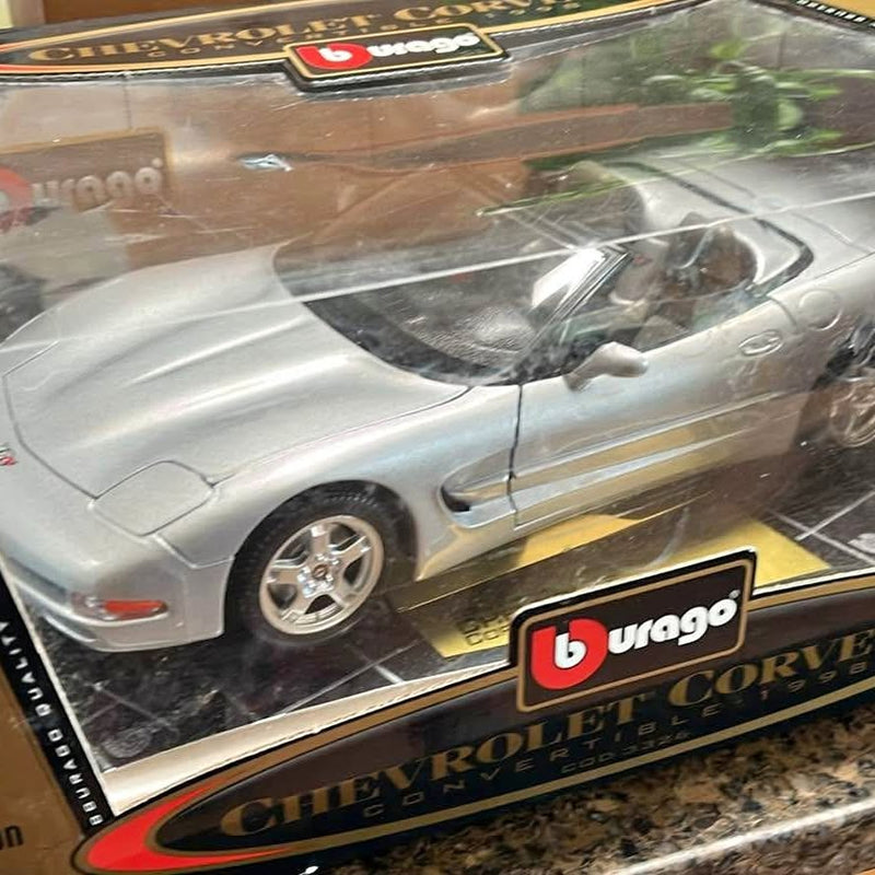 Silver Corvette convertible diecast car model, front three-quarter view, open top.