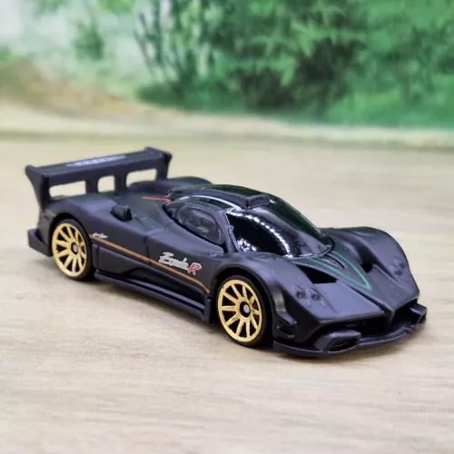 Diecast model sports car, dark blue with gold wheels and rear opening door