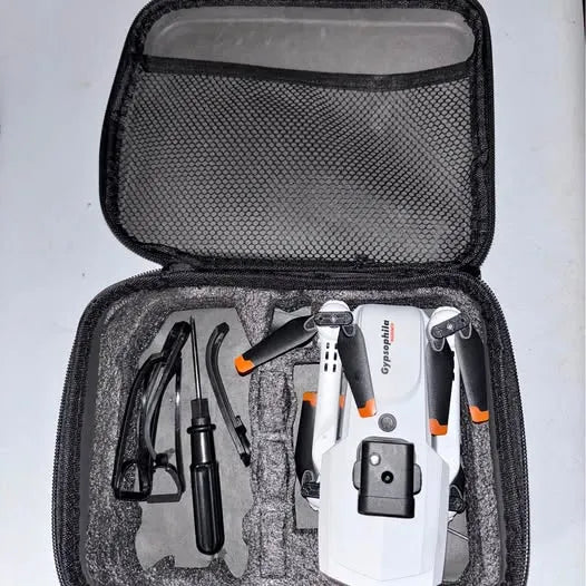 Drone kit in open zippered case, white and orange drone with propellers