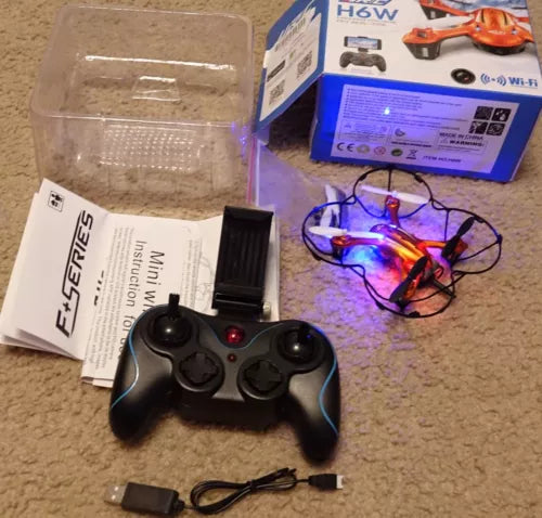 FPV quadcopter drone kit with black remote controller and small drone