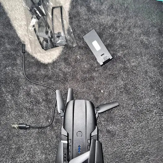 Silver compact quadcopter drone with foldable arms and front camera