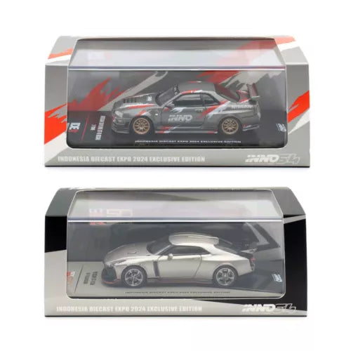 Two diecast model cars in clear display boxes, one red and one light gray