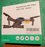 Black quadcopter drone with front camera lens and four propellers
