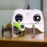 Green FPV racing drone with four prop arms and front camera mount