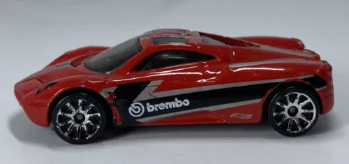 Red 1:64 Hot Wheels diecast car with black brembo stripe, detailed wheels