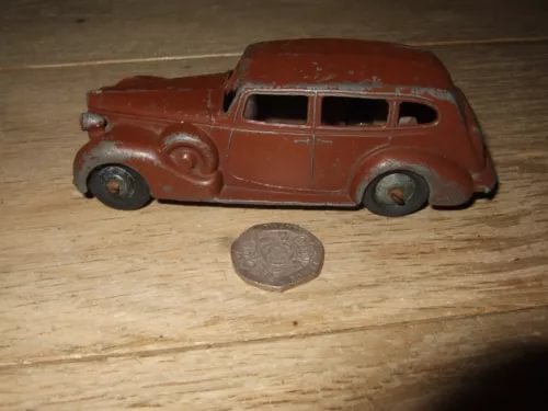 Vintage diecast touring car toy, maroon red color, detailed body and four wheels