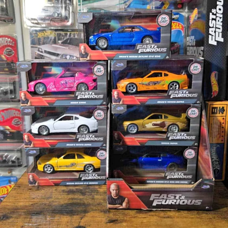 Fast and Furious diecast car collection set in boxes with logos, assorted car colors