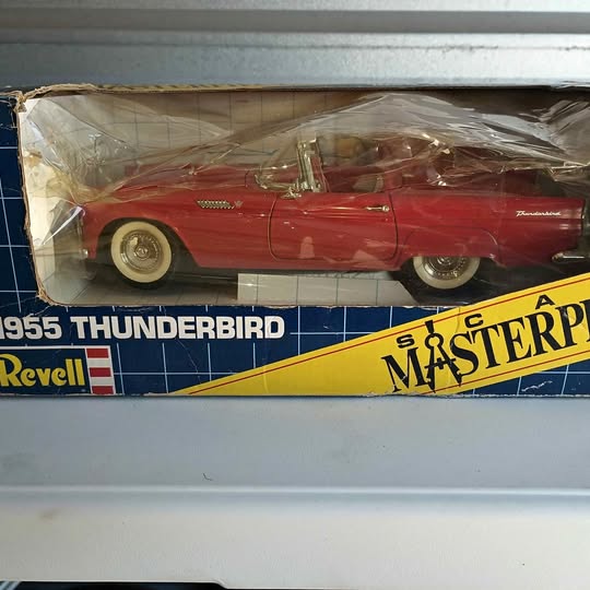 Red diecast 1955-style Thunderbird car model with chrome trim and whitewall tires