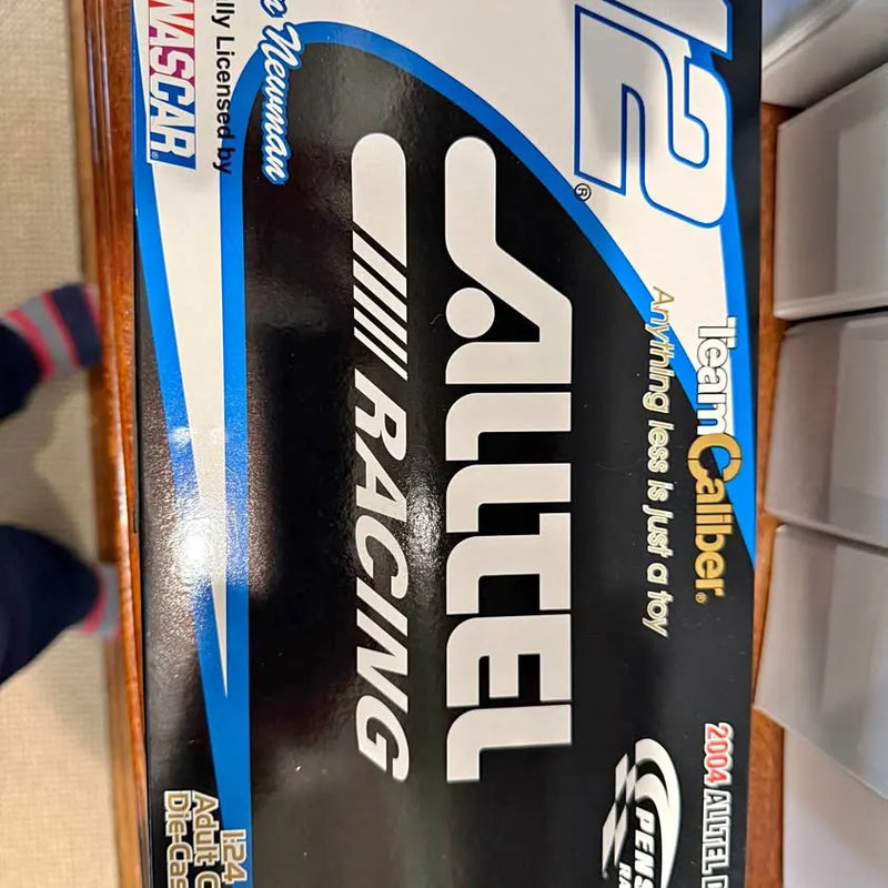 Diecast collector car model in retail box with blue-and-black packaging