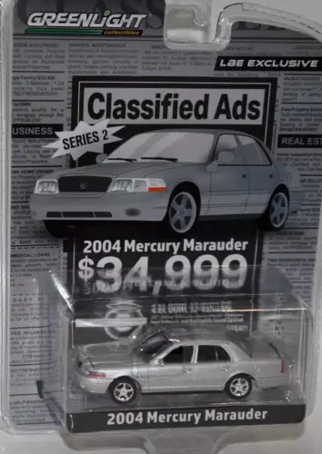 Silver diecast toy car in clear blister pack, Mercury Marauder 2004