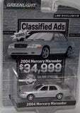 Silver diecast toy car in clear blister pack, Mercury Marauder 2004