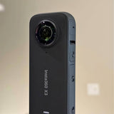 Insta360 X3 waterproof 360 action camera, front lens view, black and gray