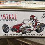 Vintage diecast race car with red and white body, open cockpit driver figure