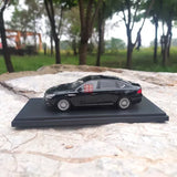1:43 GAC Trumpchi GA8 black diecast model car, side view on display base