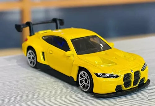 1:64 scale yellow M4 GT3 diecast model car toy, front three-quarter view