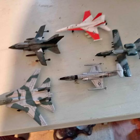 Set of five diecast model airplanes, gray and white with one red-white plane