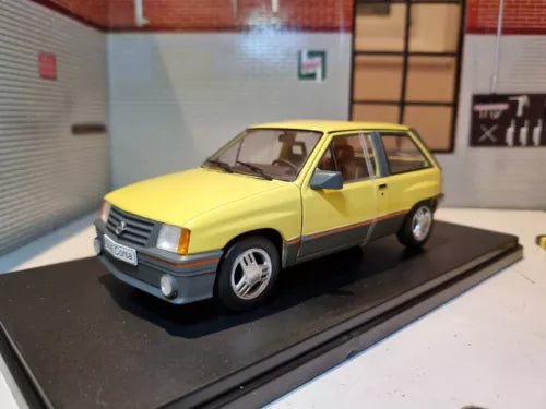 Yellow 1983 Nova diecast model car, front 3/4 view with black grille