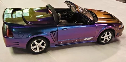 AutoWorld diecast convertible model car in purple and blue with white wheels, side view