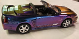 AutoWorld diecast convertible model car in purple and blue with white wheels, side view