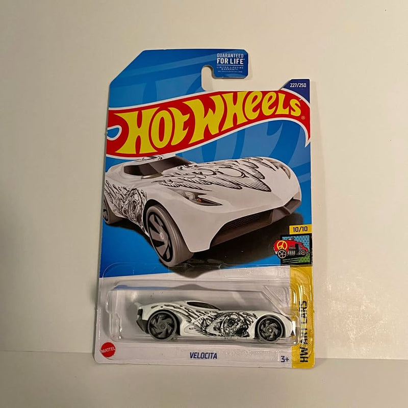 Hot Wheels Velocita diecast car in clear blister, white and black, on blue card