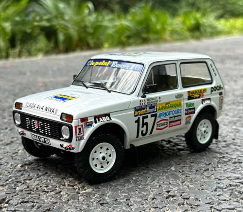 White diecast rally model car with number 157 decals, metal finish, front three-quarter view